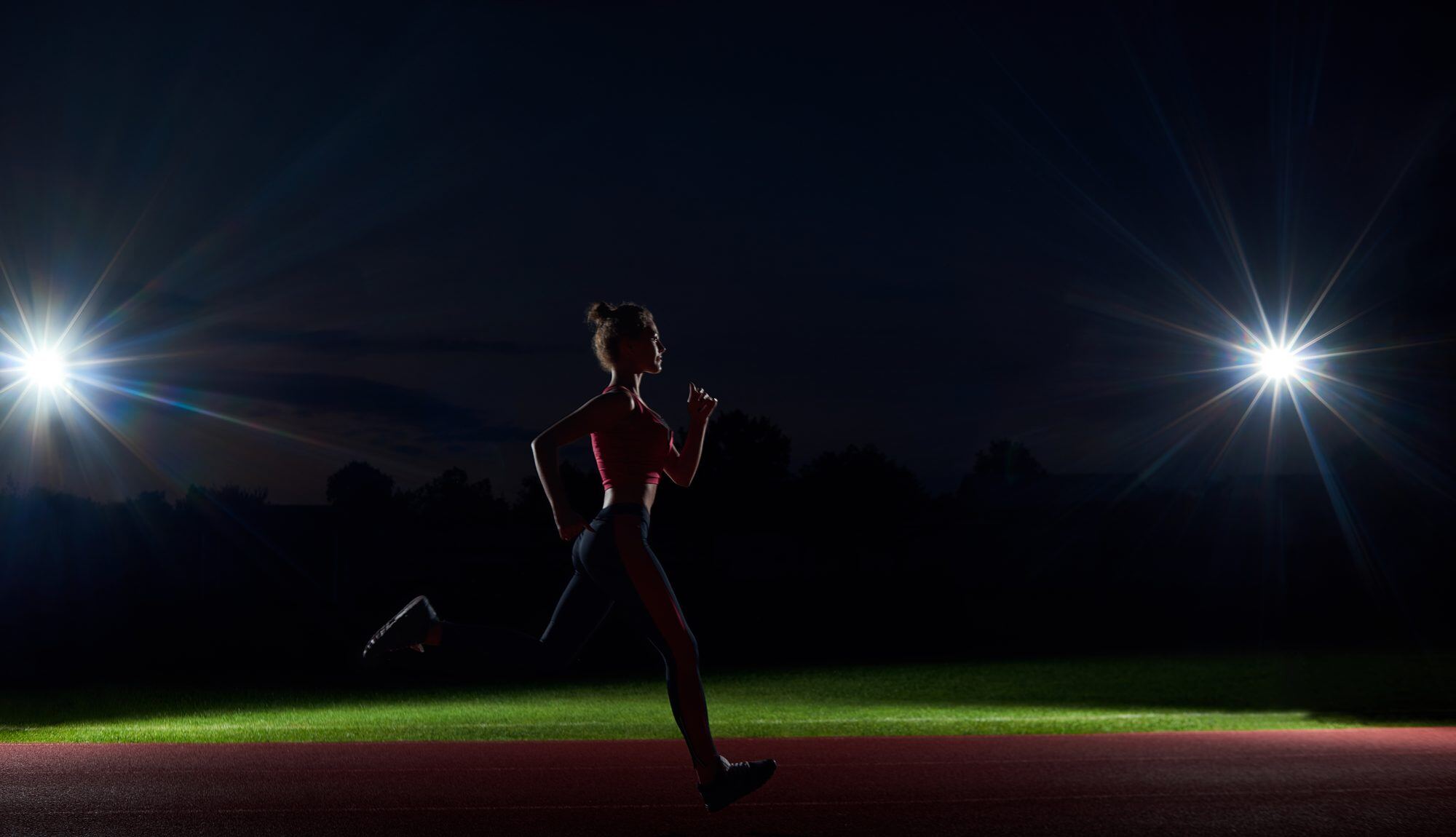 Replace with hero image: athlete under floodlights